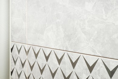 Photo of Samples of tiles with beautiful patterns on display in store, closeup