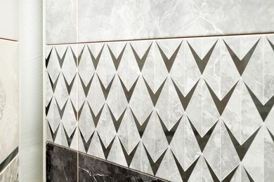 Photo of Samples of tiles with beautiful patterns on display in store, closeup