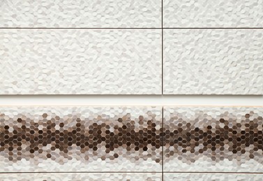 Photo of Samples of tiles with beautiful patterns on display in store, closeup