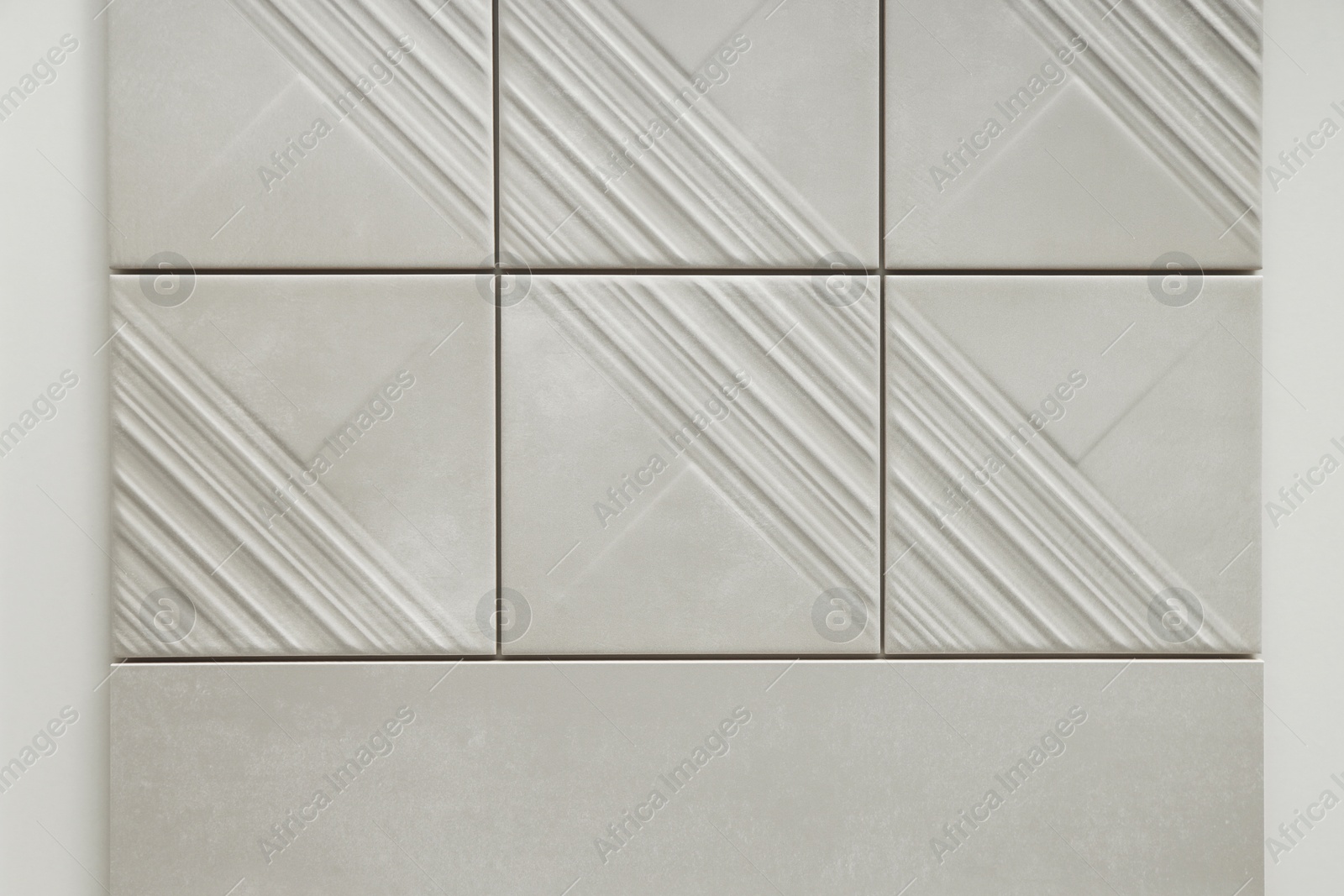 Samples of beige tiles on display in store Photo of Samples of beige tiles on display in store