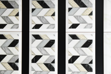 Photo of Samples of tiles with beautiful pattern as background, closeup