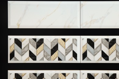 Photo of Samples of tiles with beautiful pattern as background, closeup