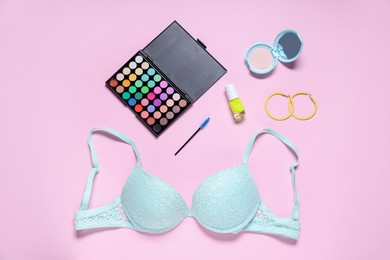 Photo of Flat lay composition with lace bra and cosmetic products on pink background