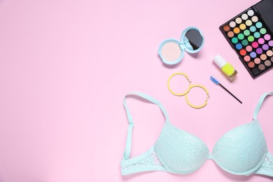 Photo of Flat lay composition with lace bra and cosmetic products on pink background. Space for text