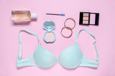 Photo of Flat lay composition with lace bra and cosmetic products on pink background