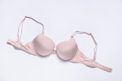 Photo of One pink bra on white background, top view