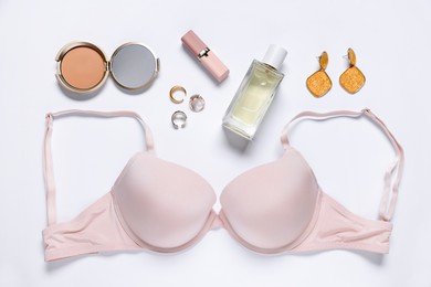 Photo of Flat lay composition with pink bra and cosmetic products on white background