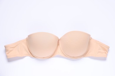 Photo of One beige bra on white background, top view