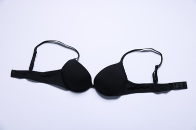 Photo of One black bra on white background, top view