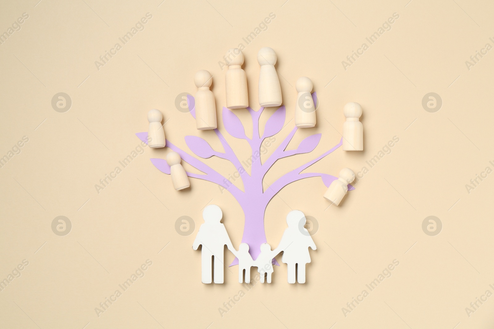Family tree made with wooden pieces and people figure on beige background, top view Photo of Family tree made with wooden pieces and people figure on beige background, top view