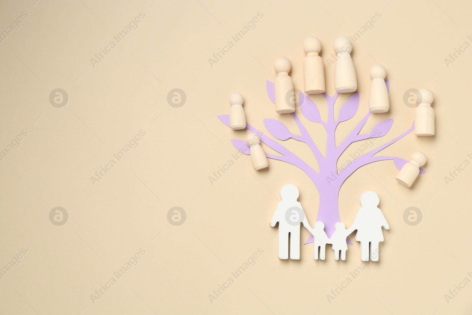 Family tree made with wooden pieces and people figure on beige background, top view. Space for text Photo of Family tree made with wooden pieces and people figure on beige background, top view. Space for text