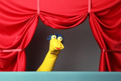 Photo of Creative puppet show on stage with red curtains
