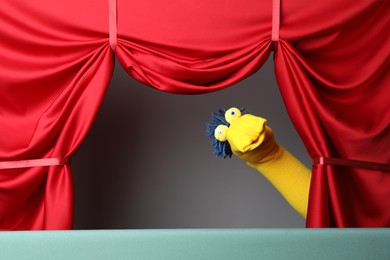 Photo of Creative puppet show on stage with red curtains