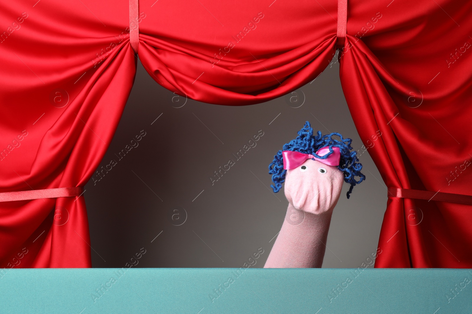 Creative puppet show on stage with red curtains Photo of Creative puppet show on stage with red curtains