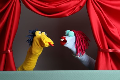 Photo of Creative puppet show on stage with red curtains