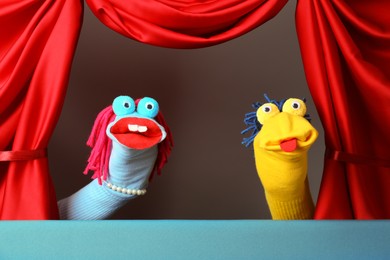Photo of Creative puppet show on stage with red curtains