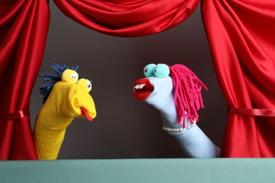 Photo of Creative puppet show on stage with red curtains