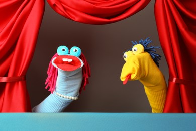 Photo of Creative puppet show on stage with red curtains