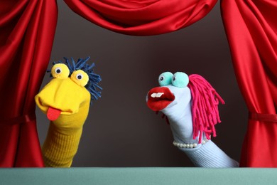 Photo of Creative puppet show on stage with red curtains
