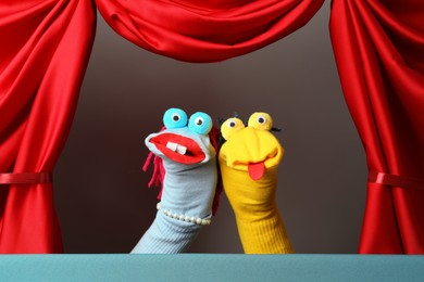 Photo of Creative puppet show on stage with red curtains