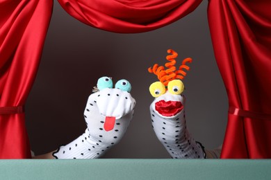 Photo of Creative puppet show on stage with red curtains