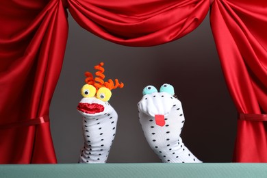 Photo of Creative puppet show on stage with red curtains