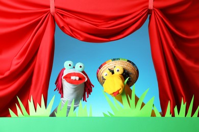 Photo of Creative puppet show on stage with decorations and red curtains