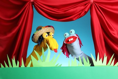 Photo of Creative puppet show on stage with decorations and red curtains