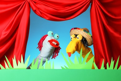 Photo of Creative puppet show on stage with decorations and red curtains