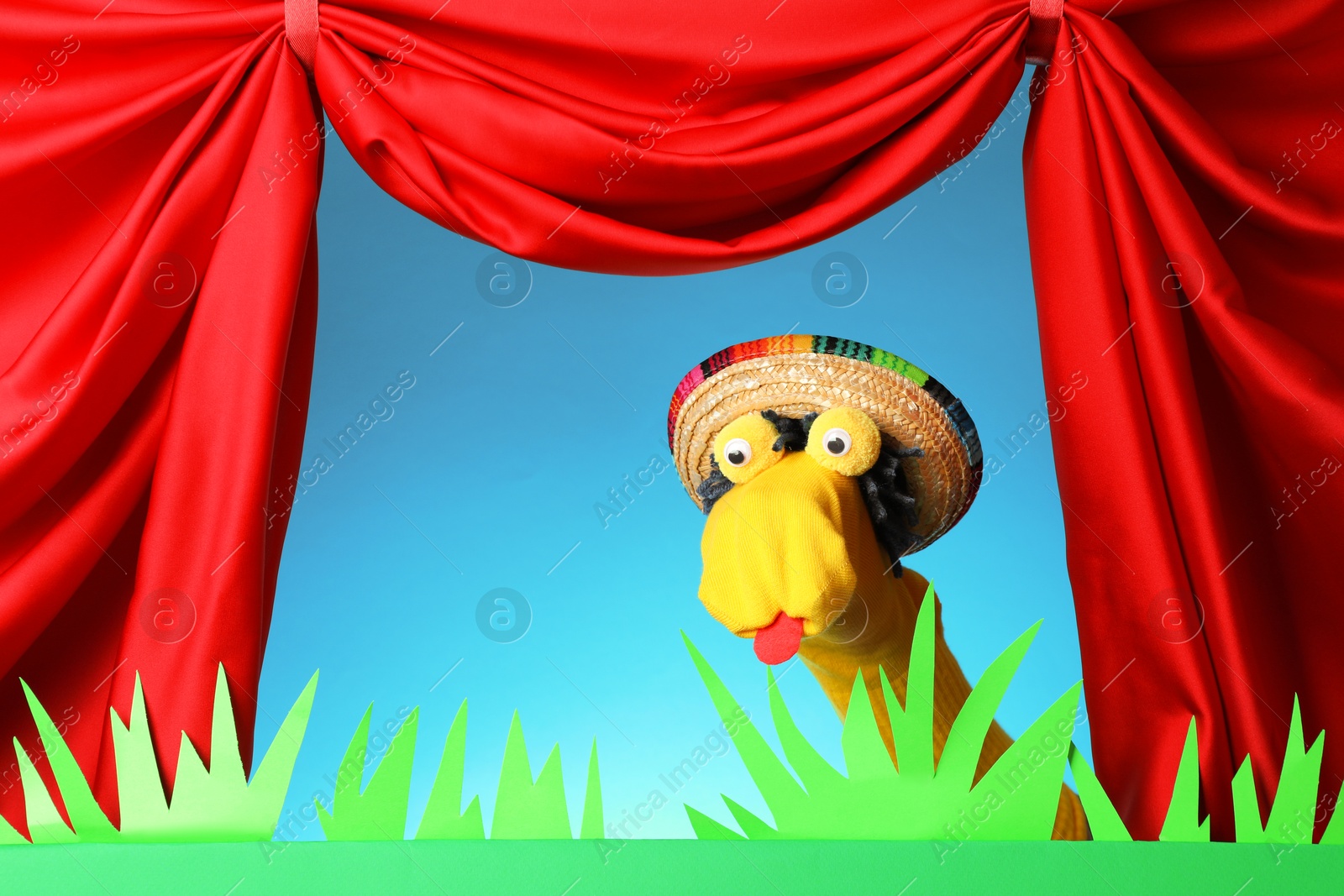 Creative puppet show on stage with decorations and red curtains Photo of Creative puppet show on stage with decorations and red curtains