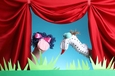 Photo of Creative puppet show on stage with decorations and red curtains