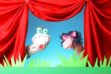 Photo of Creative puppet show on stage with decorations and red curtains