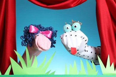 Photo of Creative puppet show on stage with decorations and red curtains
