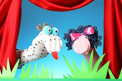 Photo of Creative puppet show on stage with decorations and red curtains