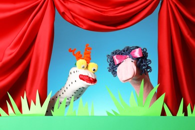 Photo of Creative puppet show on stage with decorations and red curtains