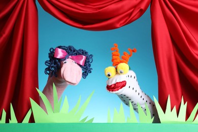 Photo of Creative puppet show on stage with decorations and red curtains