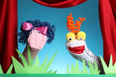 Photo of Creative puppet show on stage with decorations and red curtains