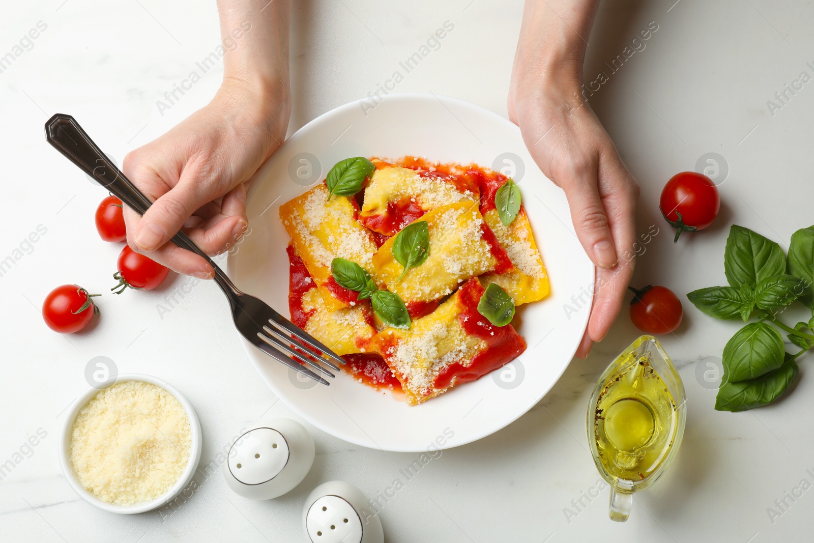 Woman eating delicious ravioli at white table, top view Photo of Woman eating delicious ravioli at white table, top view