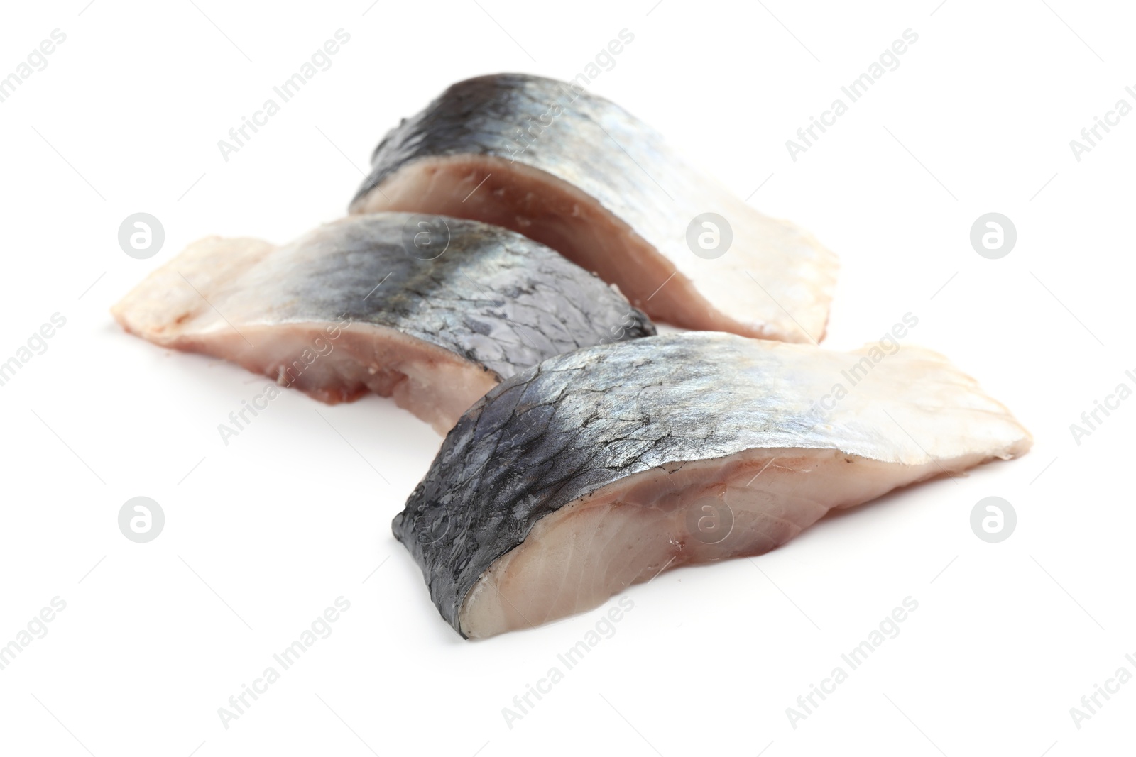 Pieces of delicious herring isolated on white Photo of Pieces of delicious herring isolated on white
