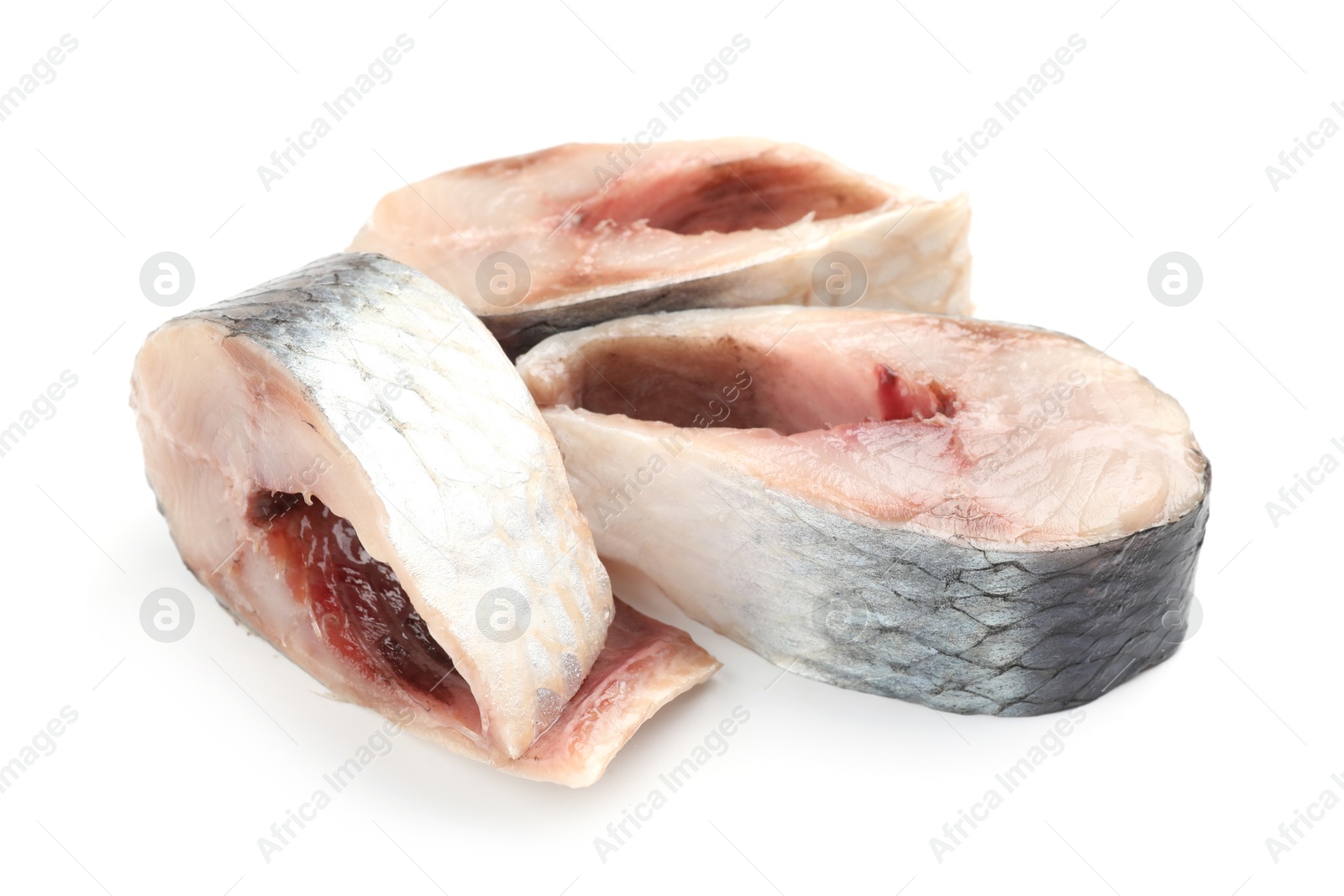 Pieces of delicious herring isolated on white Photo of Pieces of delicious herring isolated on white