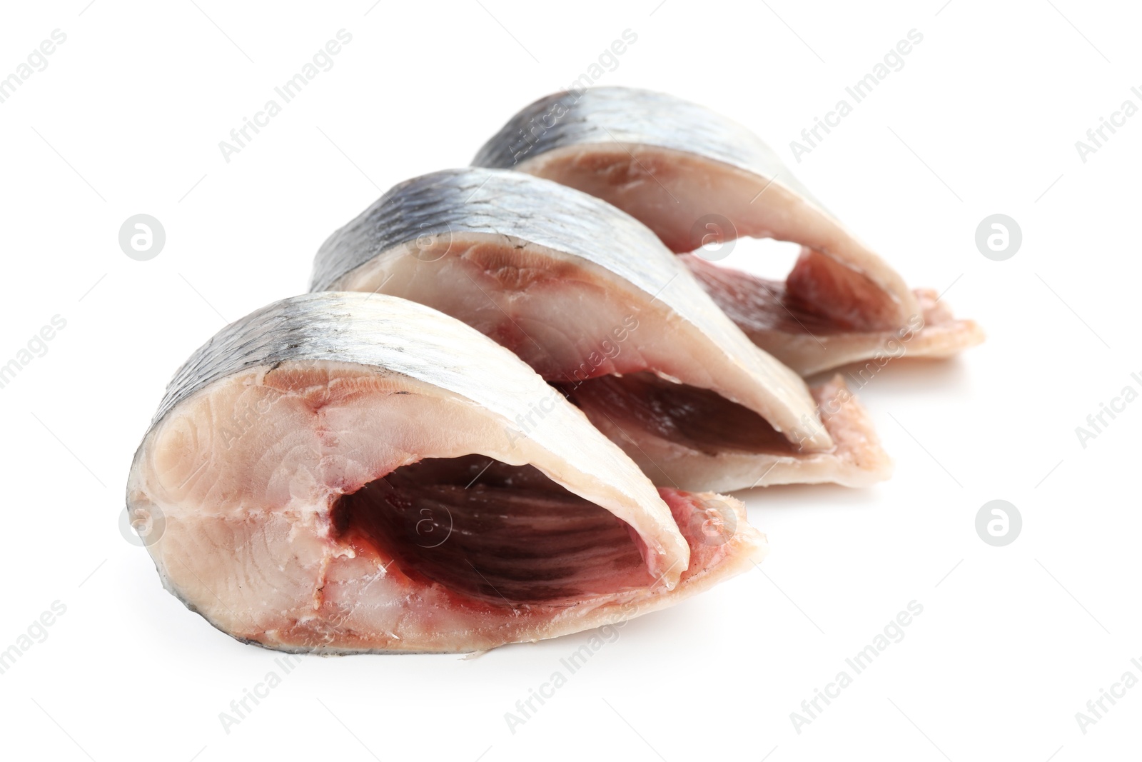Pieces of delicious herring isolated on white Photo of Pieces of delicious herring isolated on white