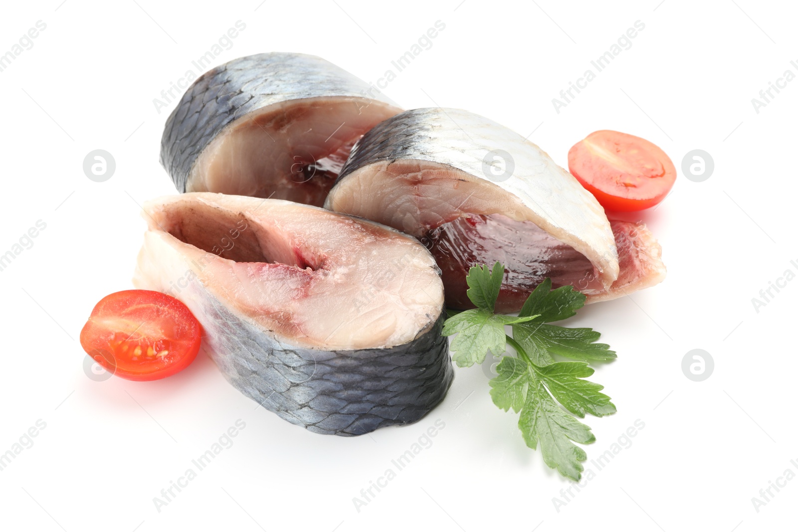 Pieces of delicious herring with tomatoes and parsley isolated on white Photo of Pieces of delicious herring with tomatoes and parsley isolated on white