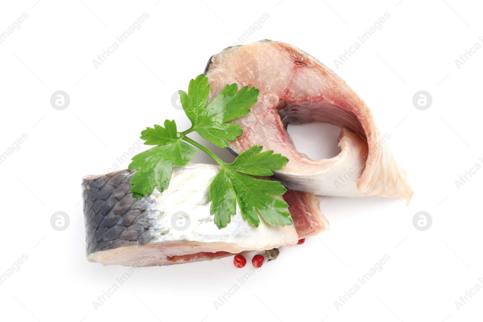 Pieces of delicious herring with peppercorns and parsley isolated on white, top view Photo of Pieces of delicious herring with peppercorns and parsley isolated on white, top view