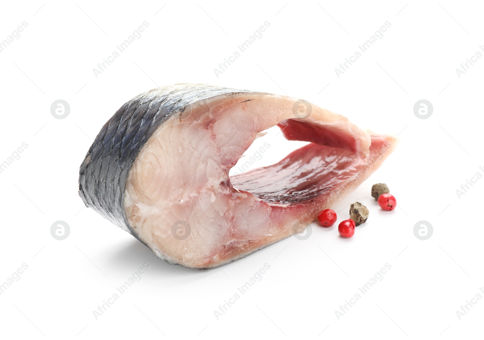 Piece of delicious herring with peppercorns isolated on white Photo of Piece of delicious herring with peppercorns isolated on white