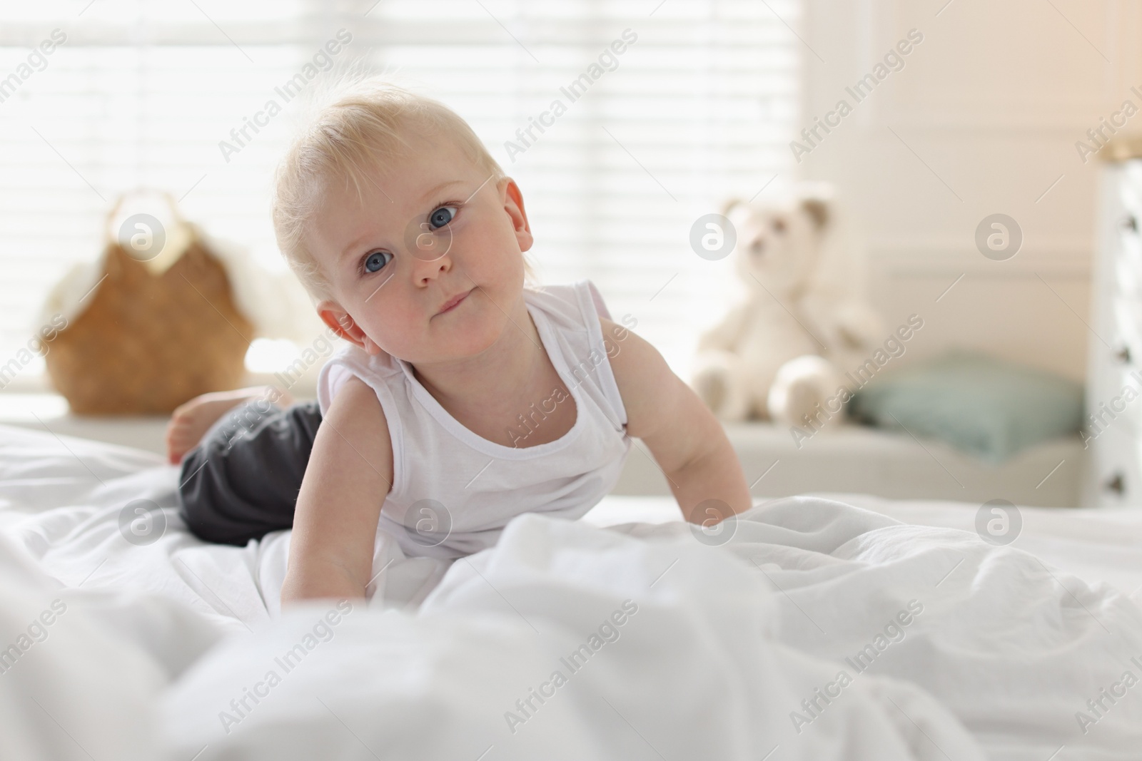 Bedtime. Cute little baby on bed at home Photo of Bedtime. Cute little baby on bed at home