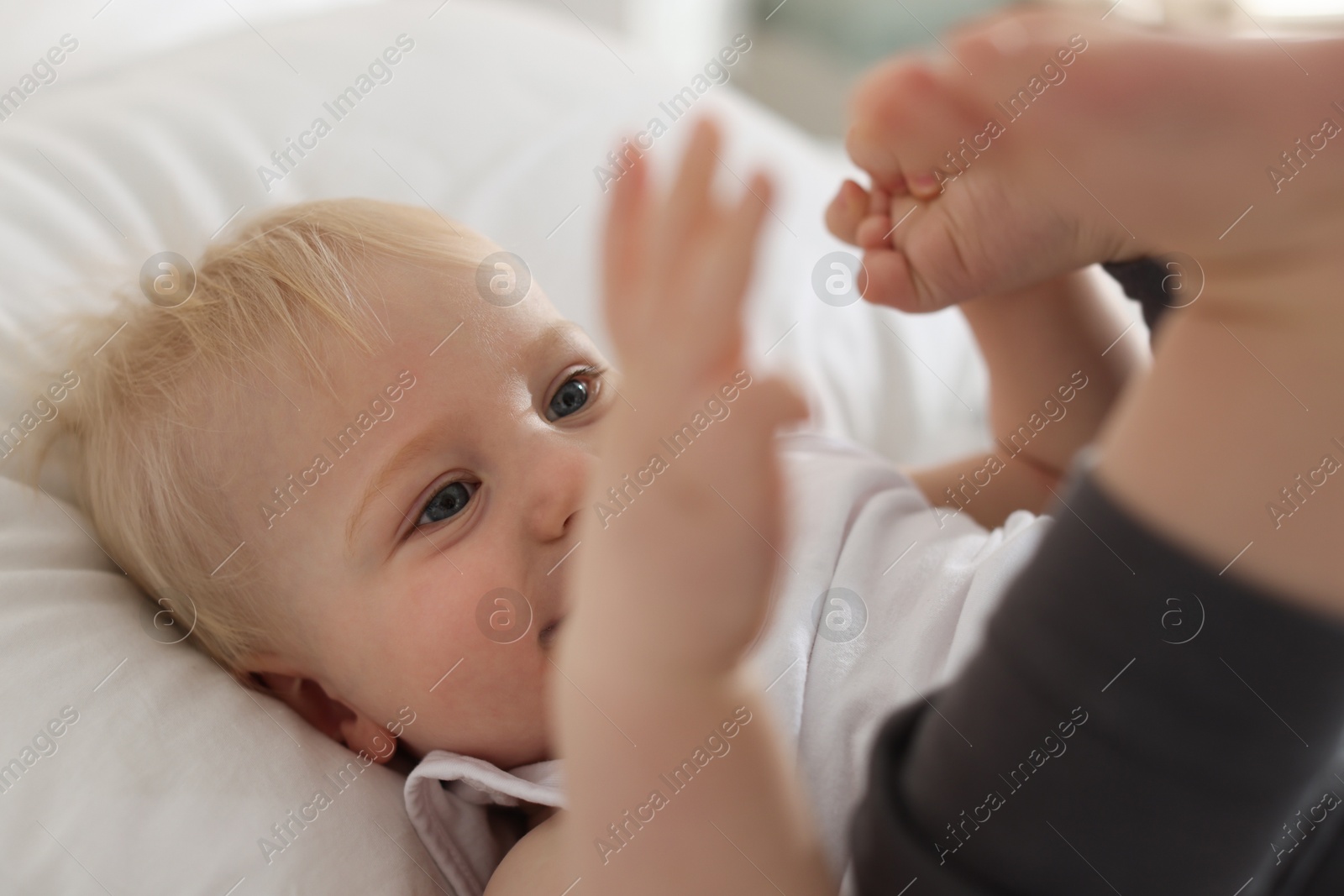 Bedtime. Cute little baby on bed at home, selective focus Photo of Bedtime. Cute little baby on bed at home, selective focus