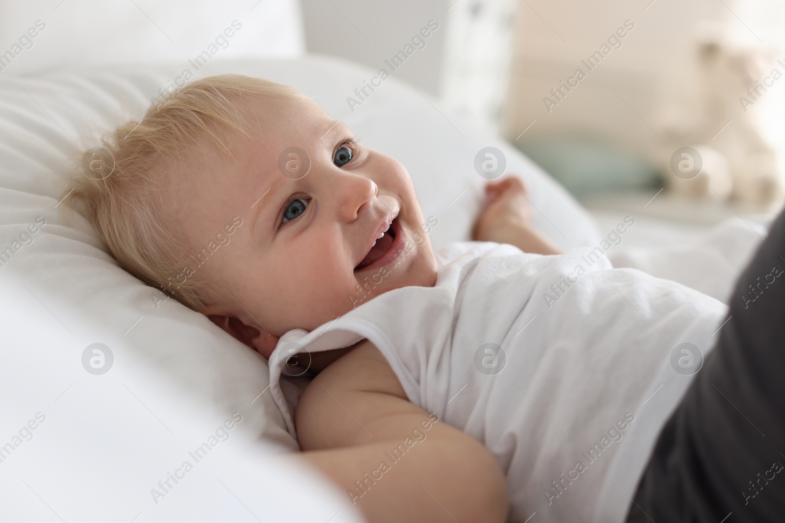 Bedtime. Cute little baby on bed at home Photo of Bedtime. Cute little baby on bed at home