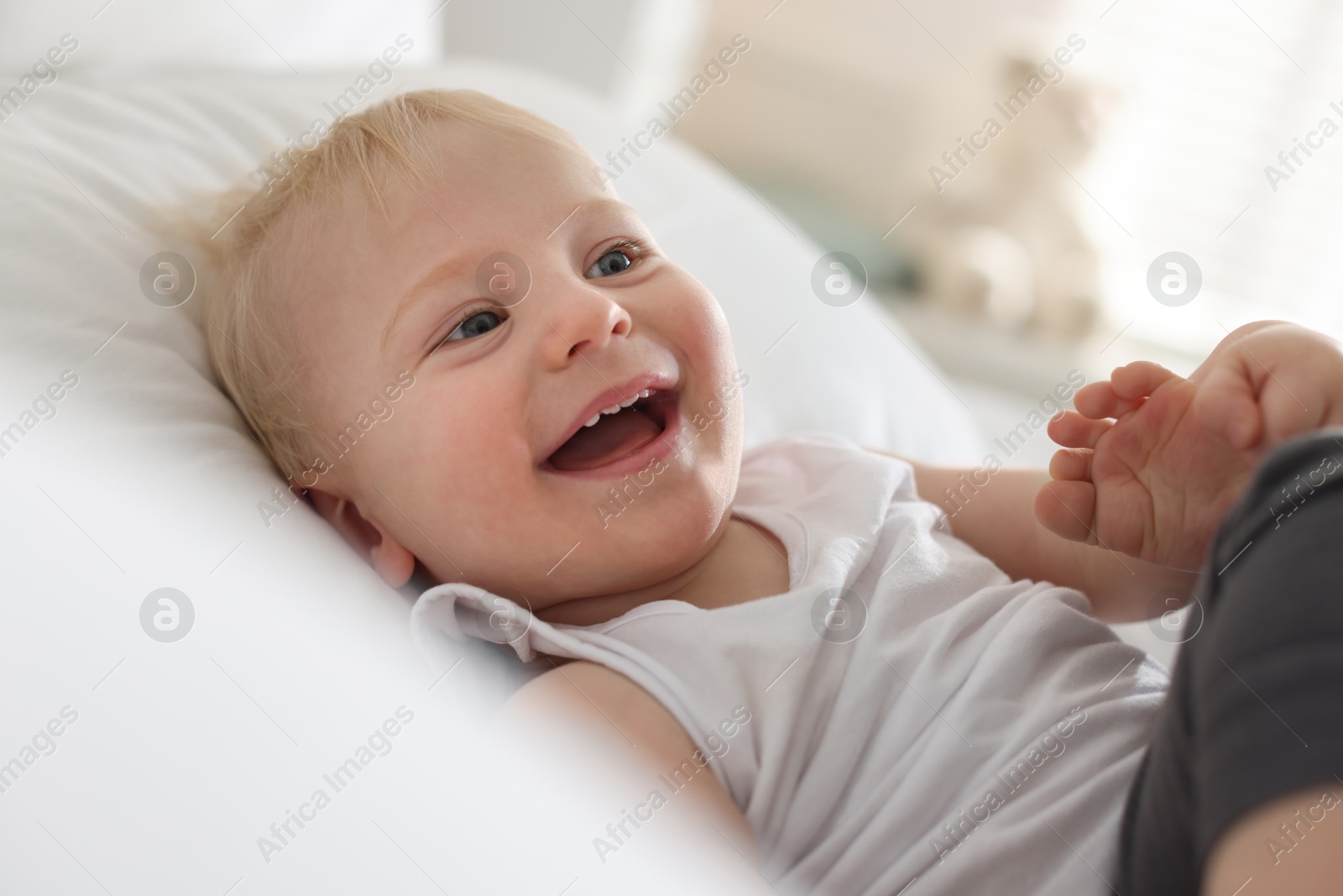 Bedtime. Cute little baby on bed at home Photo of Bedtime. Cute little baby on bed at home