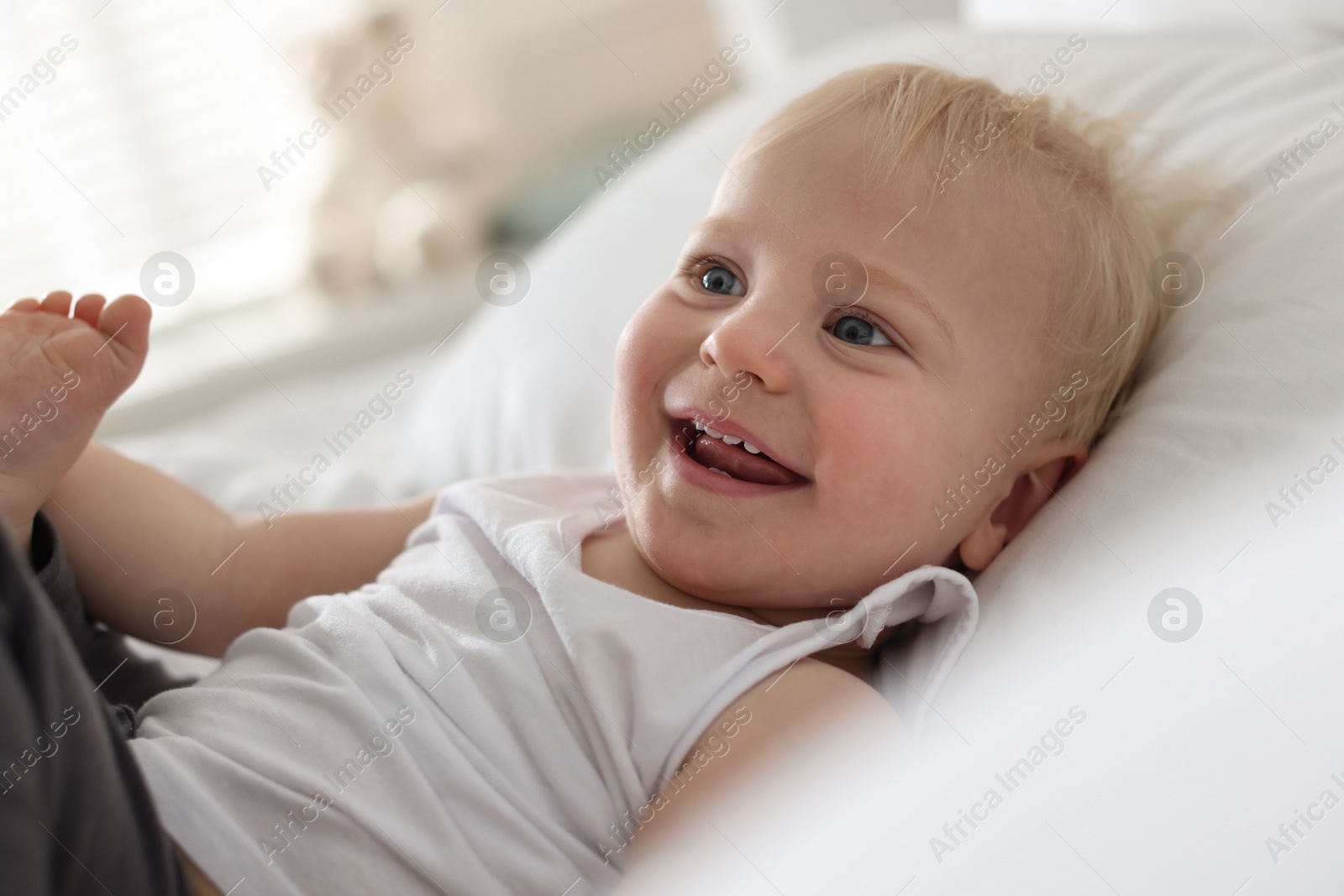 Bedtime. Cute little baby on bed at home Photo of Bedtime. Cute little baby on bed at home
