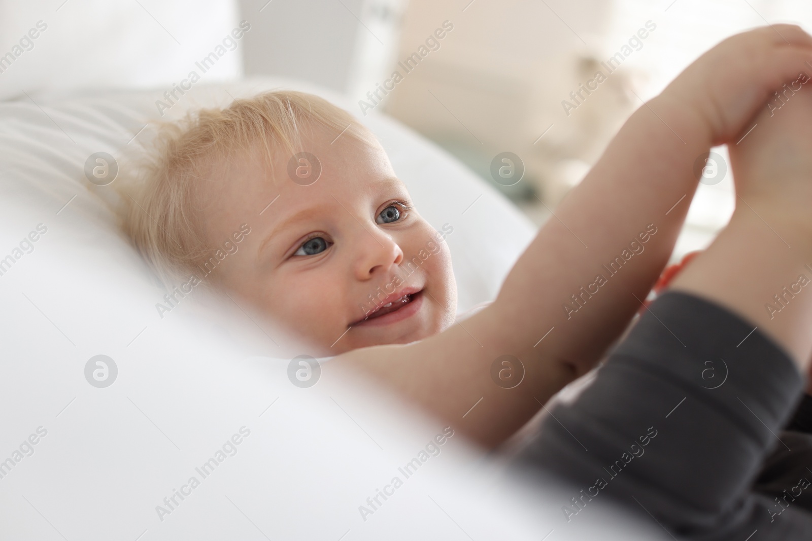 Bedtime. Cute little baby on bed at home Photo of Bedtime. Cute little baby on bed at home